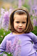 Small girl in a field of purple flowers.