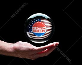 Hand holding a crystal glass forecasting ball to predict the result of the election