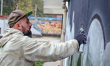 Street graffiti artist in action.