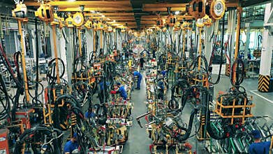 Car factory workers welding car parts on a production line