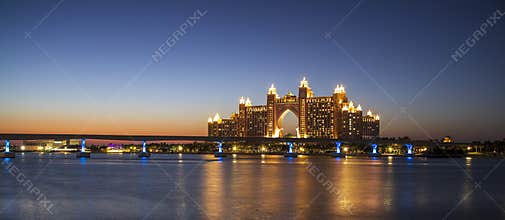 Atlantis, popular five star hotel in Dubai, UAE at night. Monorail leading to the hotel also can be seen in the picture