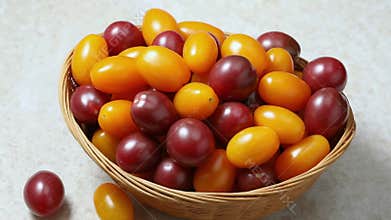 Basket with colorful cherry tomatoes close up