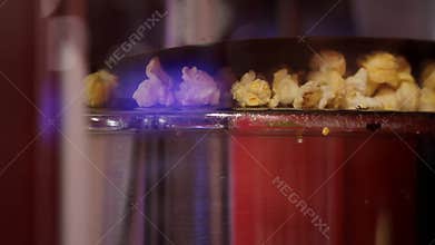 Close up shot of automatic stainless steel dry cheese caramel salt sweet flavor corn popcorn making machine popping