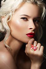 Luxury blond model with red lips & bright jewelry