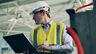 Male specialist is operating wastewater cleaning machinery