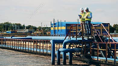 Male experts are discussing the wastewater cleaning site