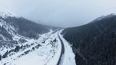 Drone captures midwinter trailer journey through mountainous area of Kananaskis, Alberta, Canada
