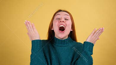 Oh my god wow. Amazed excited young woman raising hands in surprise looking at camera with big eyes, shocked by sudden
