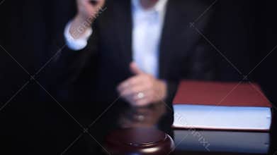 Judge hitting gavel off a block in courtroom