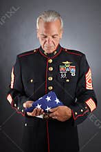 Sad Marine Holding a Flag