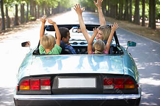 Family driving along in a sports car