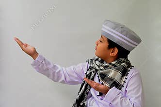asian muslim boy with praying expression, suitable for ramadhan kareem