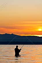 Silhouette of a fisherman at sunset.
