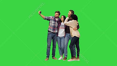 A group of cheerful students taking a selfie on a Green Screen, Chroma Key.