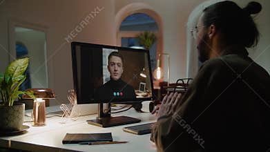 Employee communicates with boss using videocall on computer