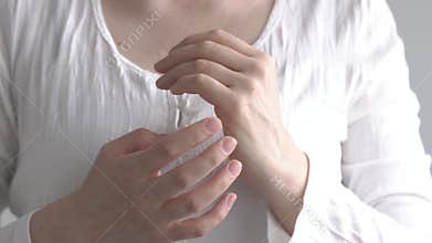 Woman practicing EFT - tapping on the side of the hand