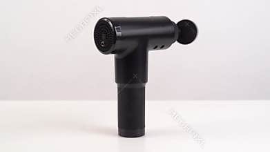 working, rotating massage gun on a white background. medical-sports device.