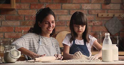 Mother and daughter prepare dough for pastries