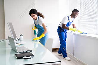 Male And Female Cleaners Cleaning Office