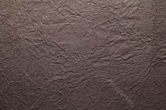 Brown color handmade paper of crumple or wrinkle texture with veins and fibers. Useful for background, 3d renderi