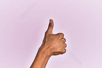 Arm and hand of black middle age woman over pink isolated background doing successful approval gesture with thumbs up, validation