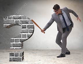 Angry man with baseball bat hitting question mark