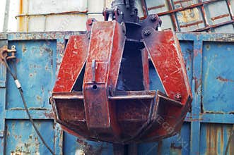 Closeup of a old red huge mechanical claw