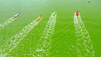 Aerial view of the rougher competition between the teams on rowing boats on the pond.
