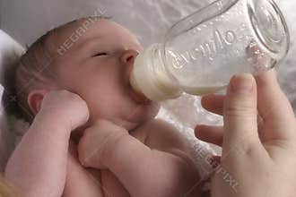 Baby being Bottle Fed by Mother