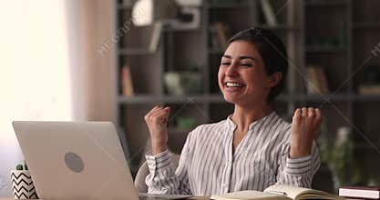 Indian employee read e-mail with good news celebrate career advance