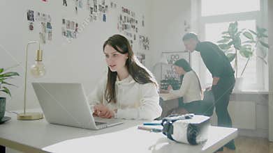 Woman conducts online video call with boss in cowork space