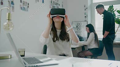 Programmer wearing virtual reality glasses tests software