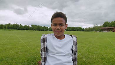 Portrait of cute school age african american boy outdoors