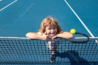 Little boy playing tennis. Sport kids, thumbs up, winner. Child with tennis racket on tennis court. Training for young