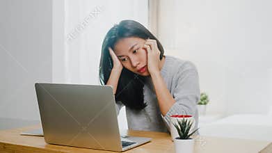Portrait of freelance Asia women casual wear using laptop hard work in bedroom at home. Working from home, remotely work, self
