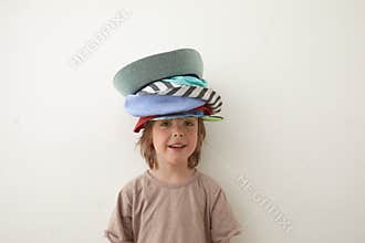 Adorable little boy wearing different hats on head