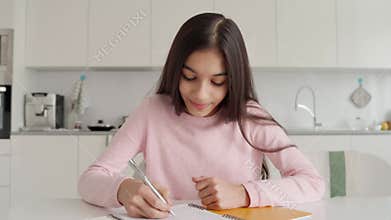 Webcam view of Indian schoolgirl on online lesson using pc laptop computer.