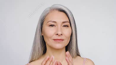 Happy middle aged mature asian woman portrait. Antiaging skincare ads.