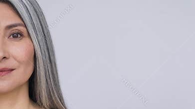 Closeup cut portrait of Asian mature woman with perfect natural skin.