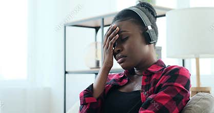 Sad woman listening music on headphones