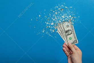 Inflation, dollar hyper inflation. Banner with blue background. One dollar bill is sprayed in the hand of a man on a