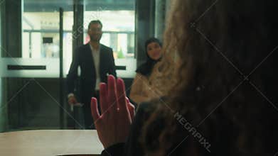 Back view concierge meet couple tourists guests hello welcome hotel reception muslim man woman travelers travel arrive