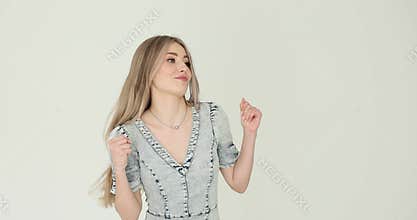 Blonde woman dances with joyful abandon with fluid movements