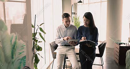 Male boss and woman secretary coordinate schedule, planning agenda