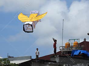 Flying kite on the rooftop, Bali, Indonesia.