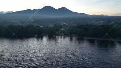 Residential area on ocean beach with mountainous landscape
