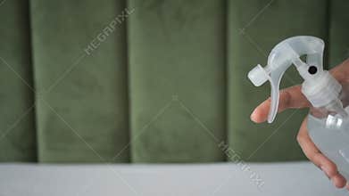 A Woman Putting Refreshener on bed