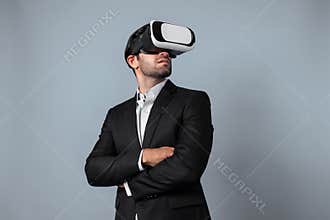 Smart business man crossing arms and standing at white background. Deviation.