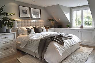 Modern bedroom with white wardrobes, wooden flooring, and large window for contemporary design