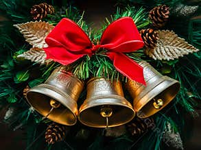 Traditional Christmas Bell Decoration with Red Ribbon on Evergreen Wreath